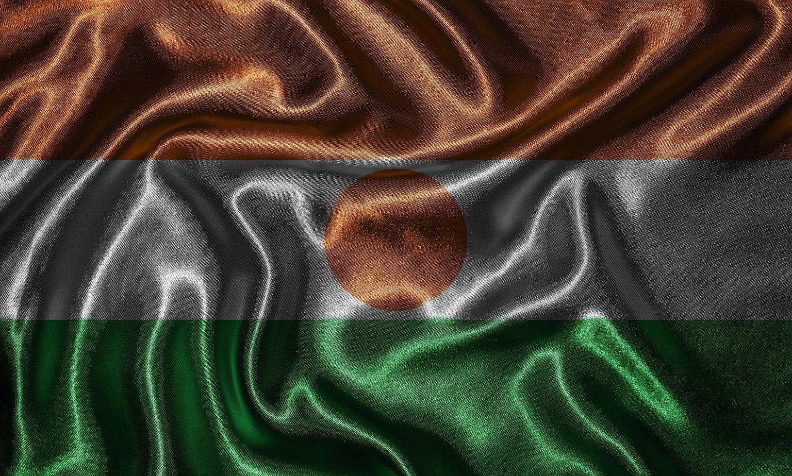 Tapete von Niger Flag und wehende Flagge von Stoff. foto