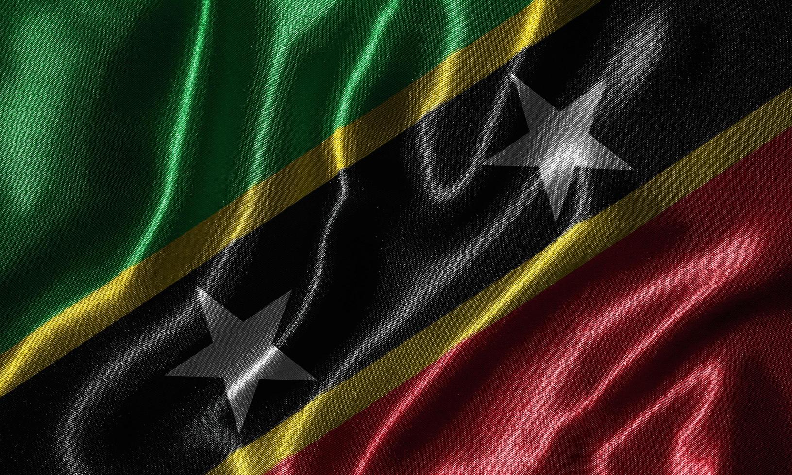 Tapete von St. Kitts und Nevis-Flagge und wehende Flagge von Stoff. foto