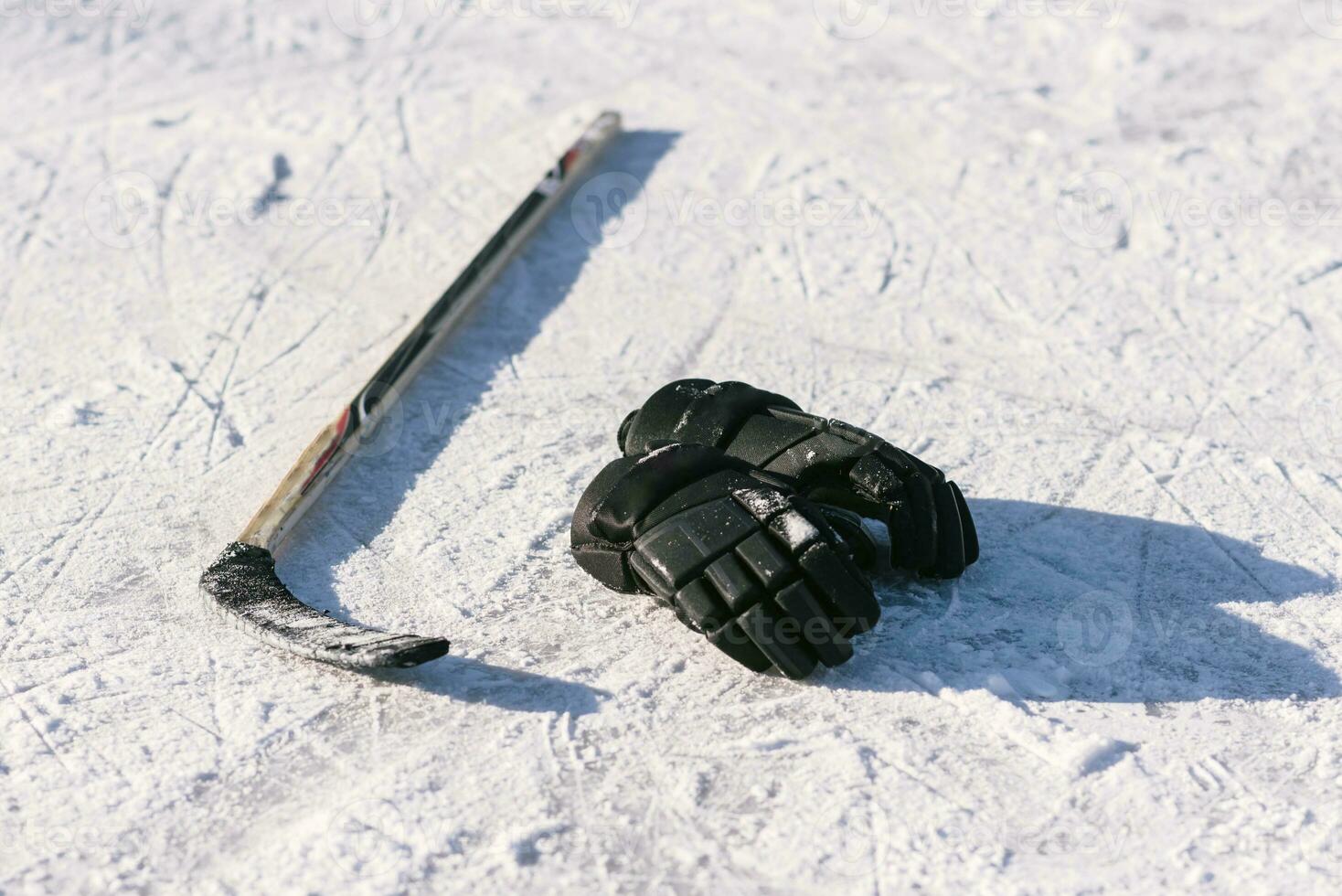 das Handschuhe und Eishockey Stock legen auf das Schnee foto