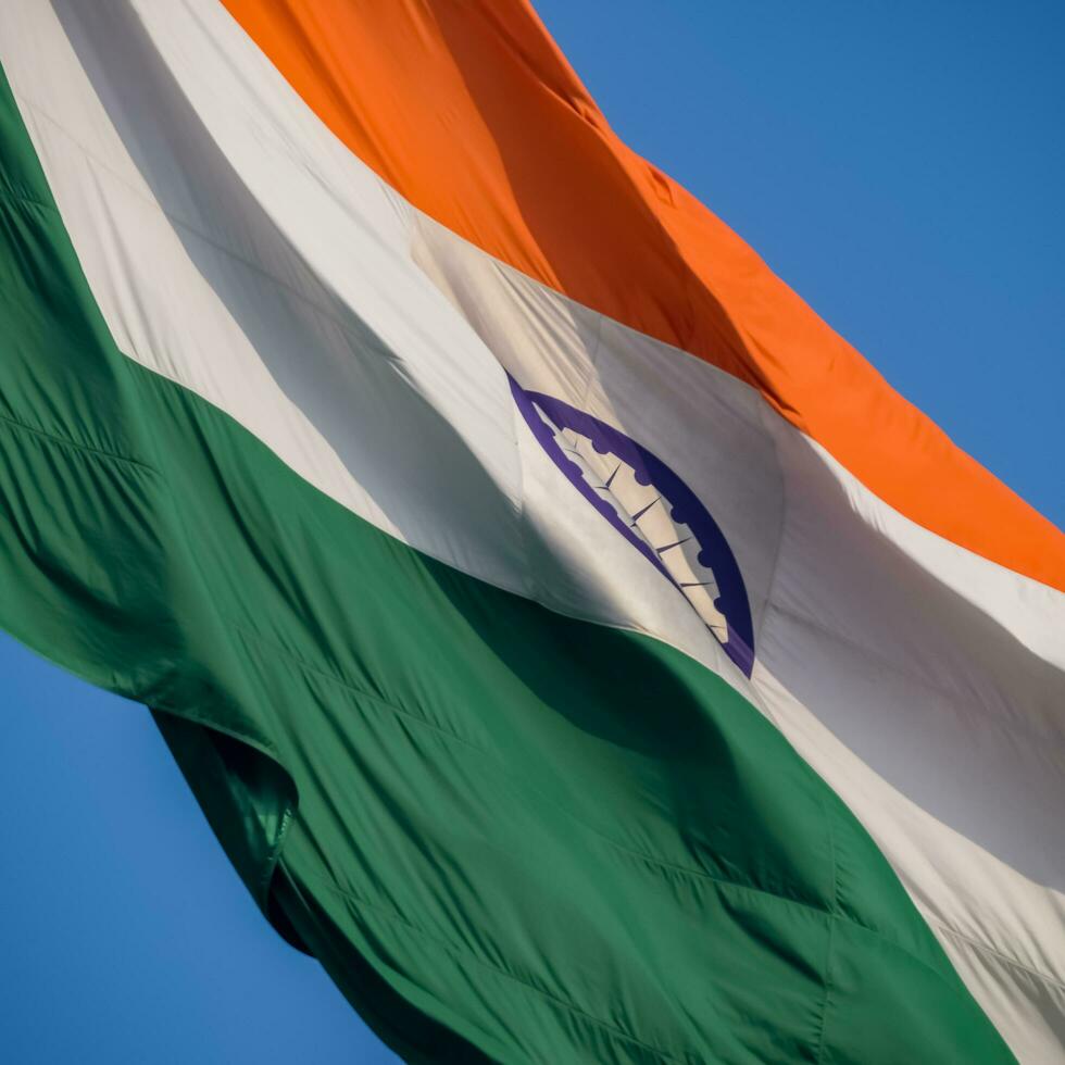 Indien-Flagge, die hoch am Connaught-Platz mit Stolz auf den blauen Himmel fliegt, Indien-Flagge flattert, indische Flagge am Unabhängigkeitstag und Tag der Republik Indien, Schuss nach oben geneigt, indische Flagge schwenkend, Har Ghar Tiranga foto