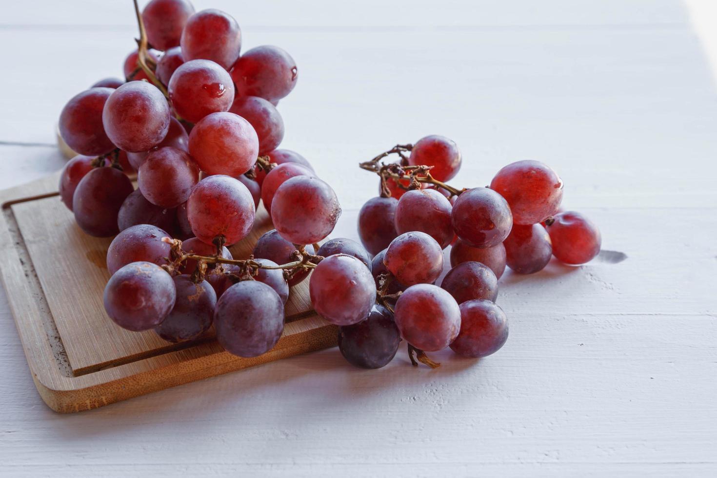 frische rote Traubenfrucht auf Holzuntergrund foto