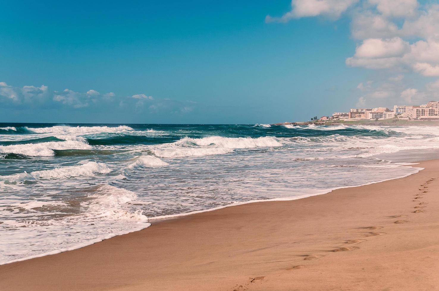 Paradise Ocean Beach, Fußabdrücke im nassen Sand, ferne Hotels foto