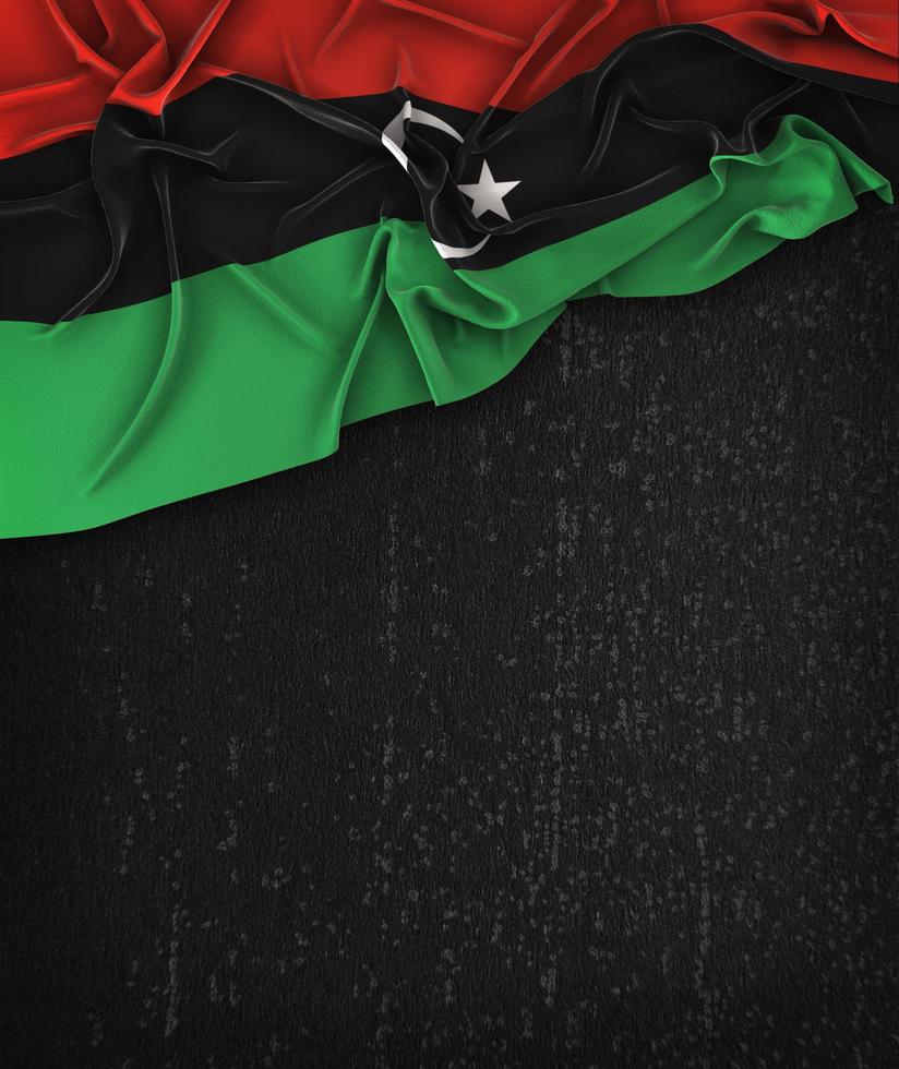 Libyen-Flaggenweinlese auf einer schwarzen Tafel des Schmutzes mit Platz für Text foto