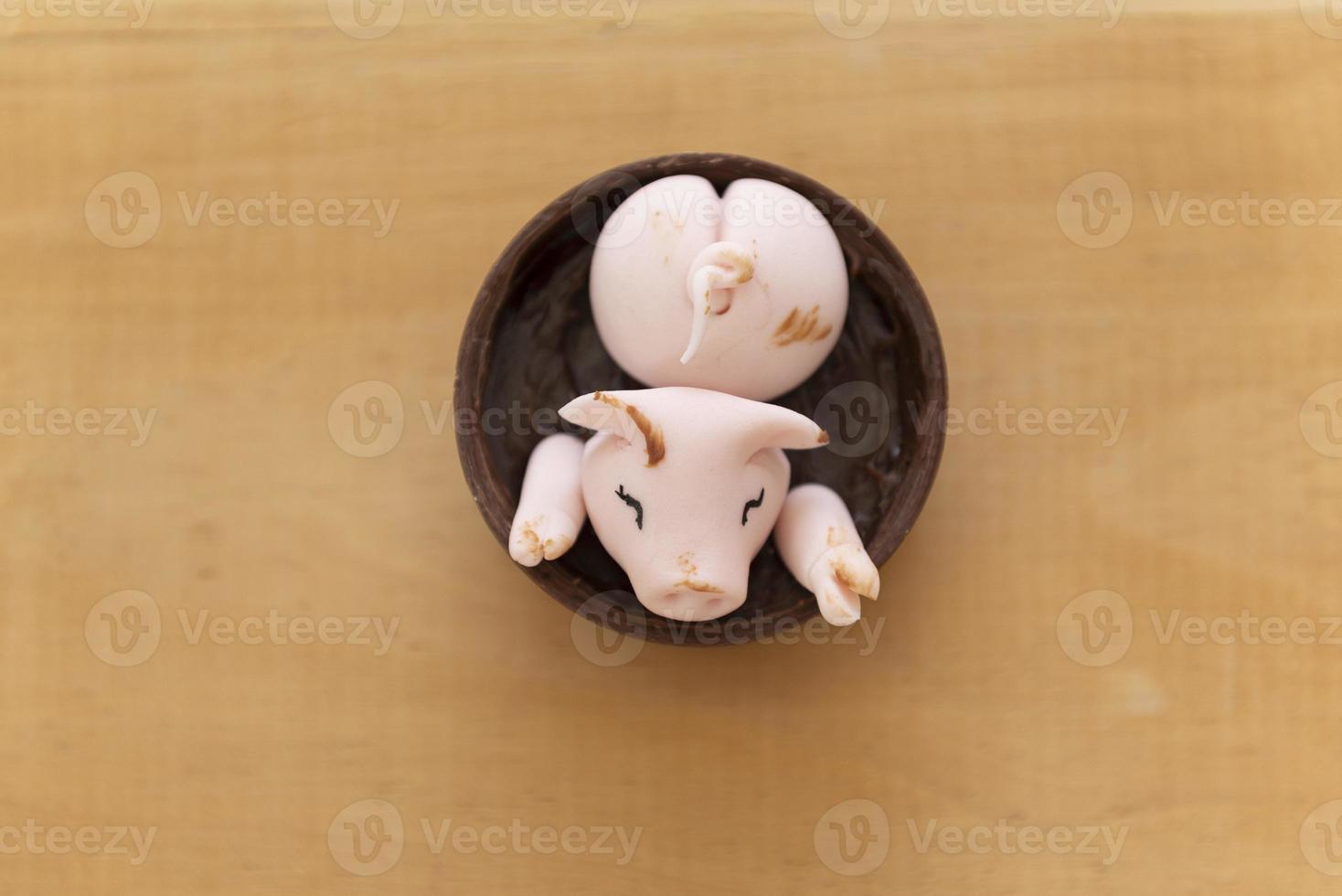 Draufsicht auf dekorierte Süßigkeiten, glückliche süße rosa Schweine, die im Schlamm spielen foto