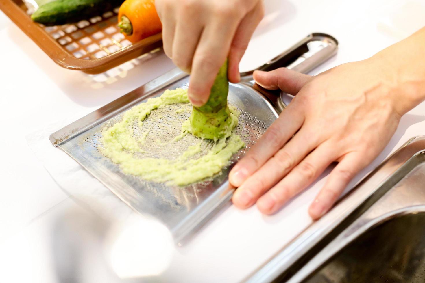 Sushi-Chef reibt frischen Wasabi, frische Wasabi-Wurzel foto