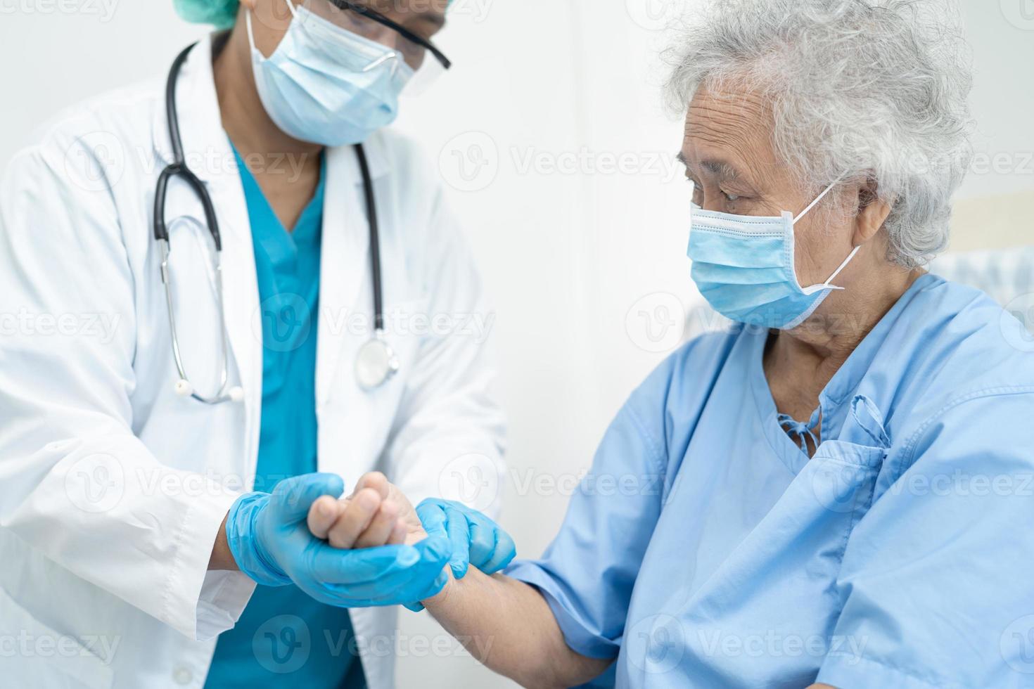 Asiatischer Arzt hilft asiatischen älteren Patienten im Pflegekrankenhaus. foto