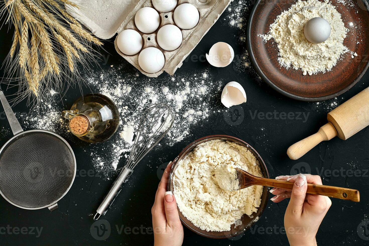 weiblich Hände Herstellung Mischen Teig im braun Schüssel auf schwarz Tisch, Backen Vorbereitung Nahansicht. foto