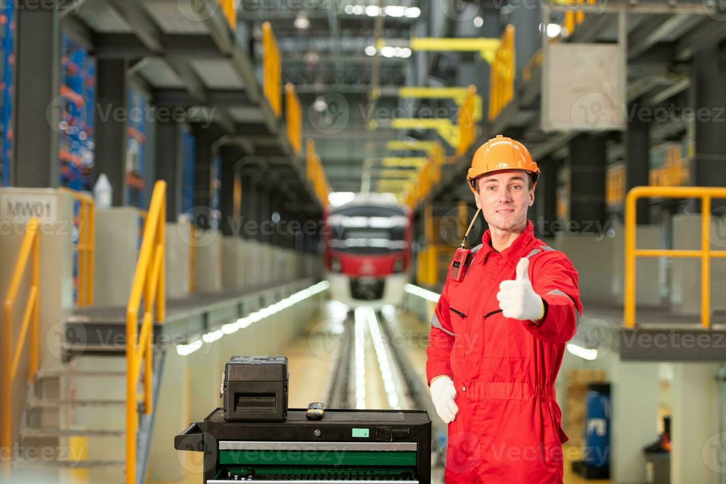 Porträt von Ingenieur mit Reparatur Werkzeuge von das elektrisch Zug Industrie Dort ist ein elektrisch Zug im das Zug Reparatur Fabrik wie das Hintergrund Bild. foto