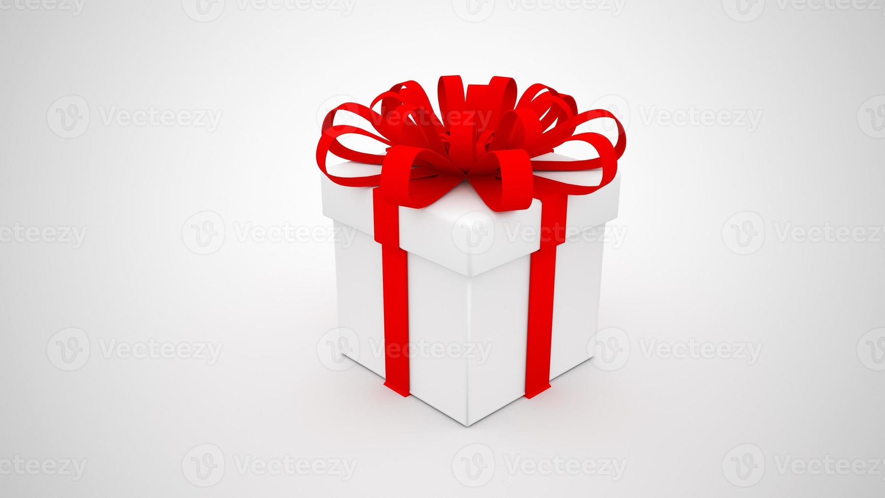 weiße Geschenkbox mit rotem Band auf weißem Hintergrund foto