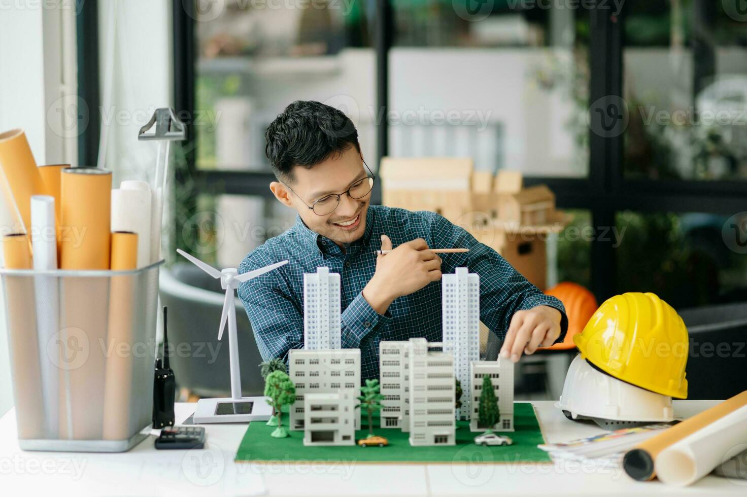 Geschäft Menschen haben Beratung Über Wind Energie beim Unternehmen Büro. auf architektonisch Projekt Seite? ˅ und Herstellung Modell- Haus. asiatisch Industrie foto