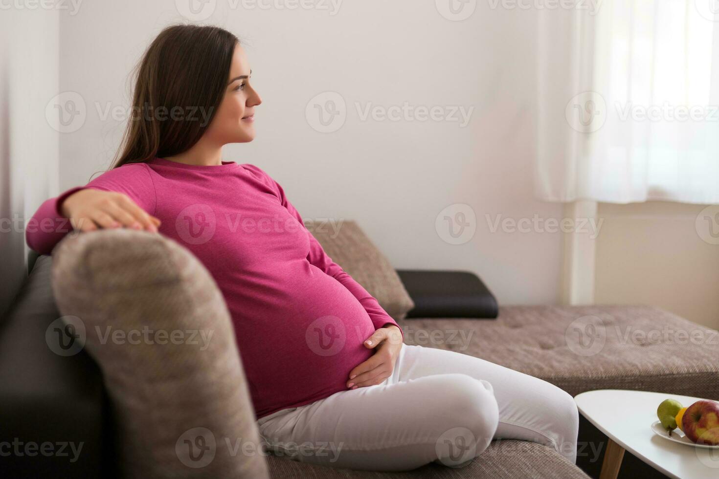 schön schwanger Frau genießt ruhen auf Sofa beim ihr heim. foto