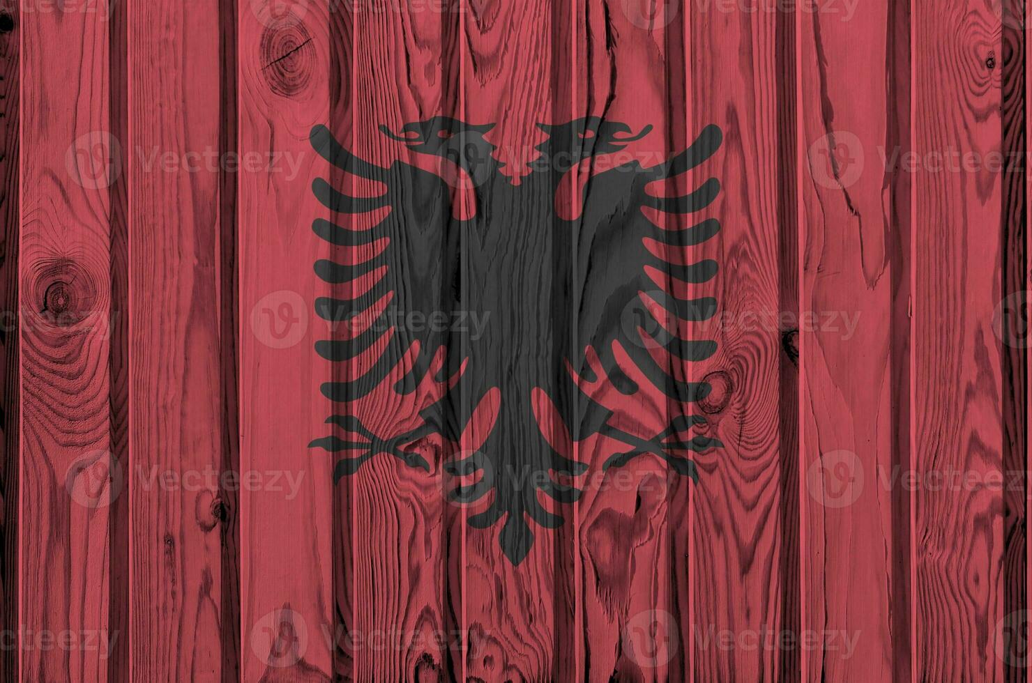 Albanien Flagge abgebildet im hell Farbe Farben auf alt hölzern Mauer. texturiert Banner auf Rau Hintergrund foto