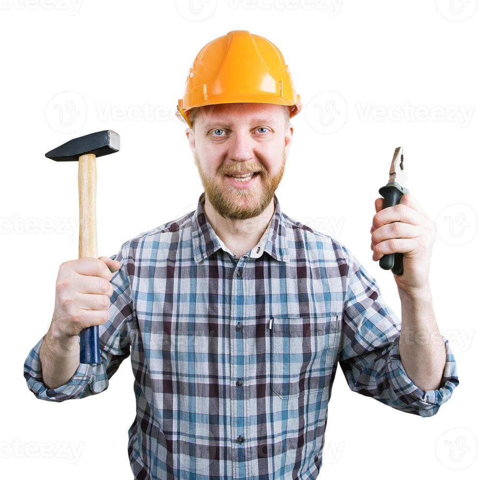 Mann mit Helm mit Hammer und Zange foto