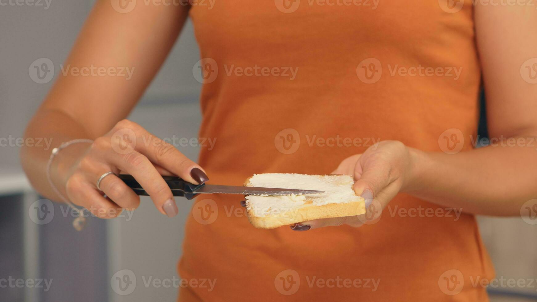 Verbreitung Butter auf getoastet Brot zum köstlich Frühstück. Messer verschmieren Sanft Butter auf Scheibe von Brot. gesund Lebensstil, Herstellung Morgen köstlich Mahlzeit im gemütlich Küche. traditionell lecker Mittagessen foto