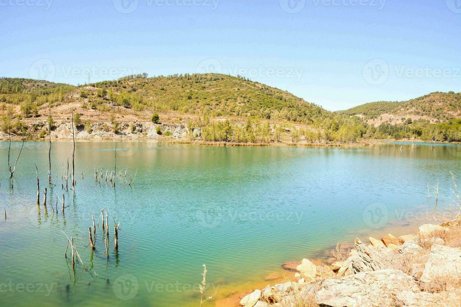 ein See im das Berge mit Bäume und Felsen foto