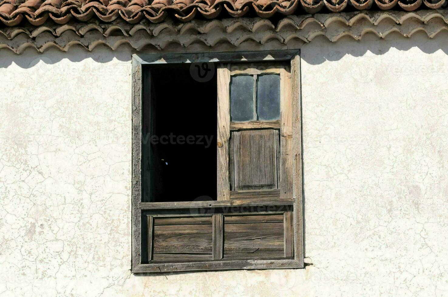 ein Fenster mit ein hölzern Tür und gefliest Dach foto