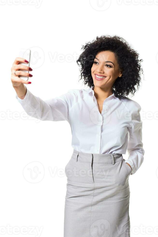 schön Brünette Frau im klassisch Weiß Hemd und Rock machen Selfie auf das Telefon. foto