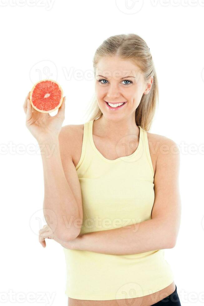 sportlich Frau halten Grapefruit foto