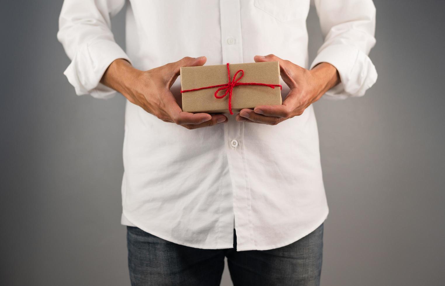 Hand, die Geschenkbox, Geschenkbox des neuen Jahres, Weihnachtsgeschenkbox, Kopienraum hält. Weihnachten, Jahr, Geburtstagskonzept. foto