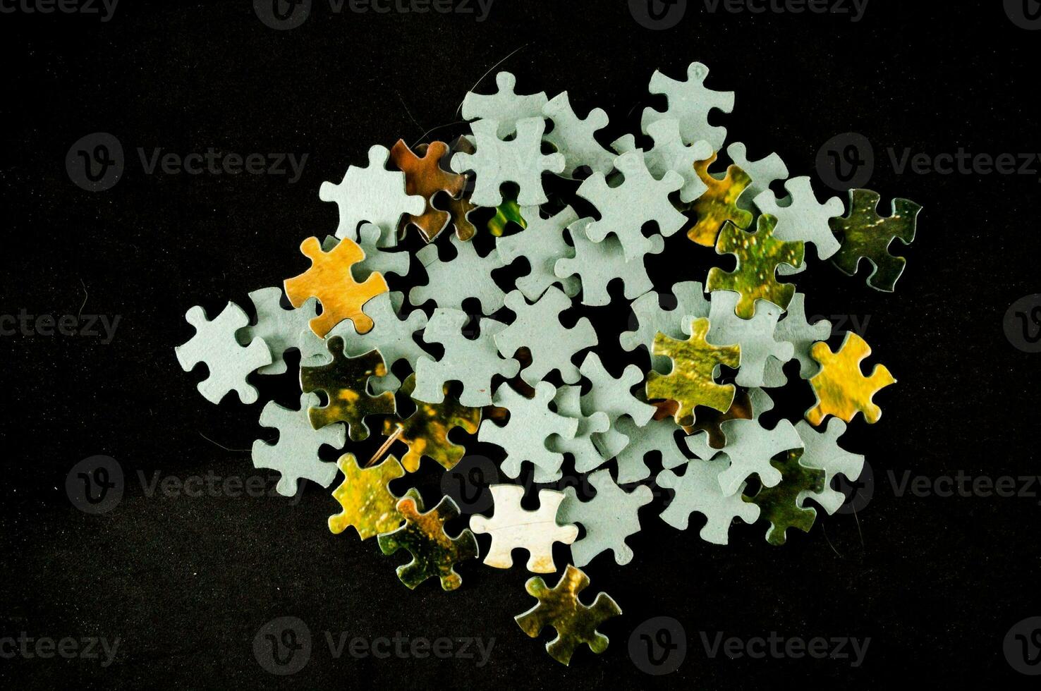 ein Stapel von Puzzle Stücke auf ein schwarz Hintergrund foto