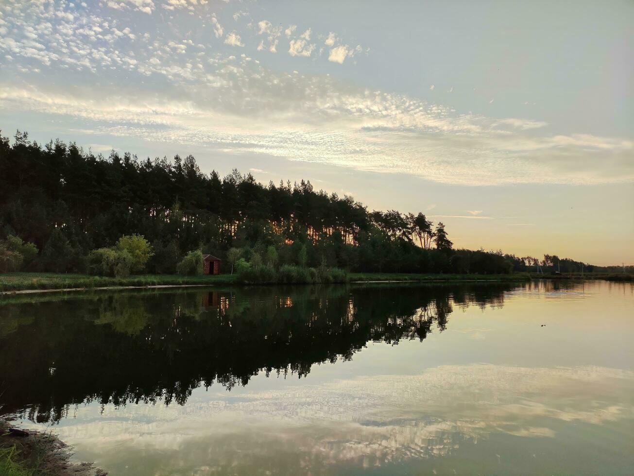 See und Wald im Sonnenuntergang, malerisch Hintergrund foto