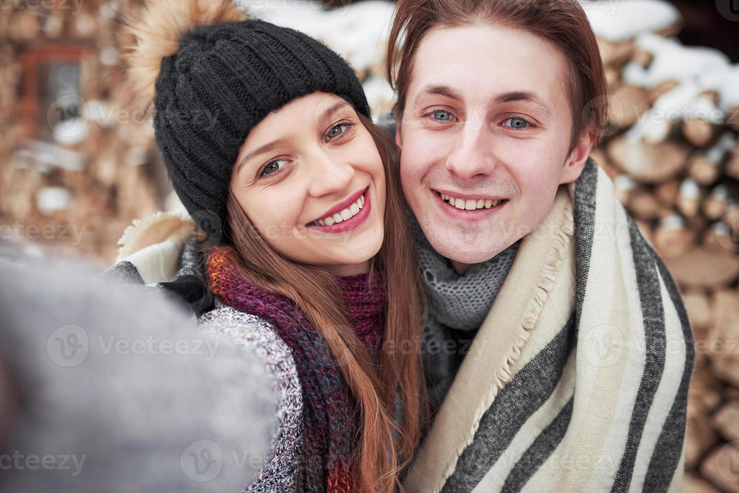 Weihnachten glückliches Paar in der Liebe umarmt im verschneiten kalten Winterwald, Kopienraum, Neujahrsfeier, Urlaub und Urlaub, Reisen, Liebe und Beziehungen foto