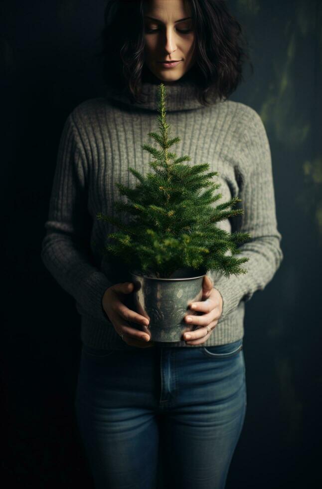 ai generiert ein Frau hält ein Silber eingetopft Baum mit ein golden Sweatshirt und Jeans foto