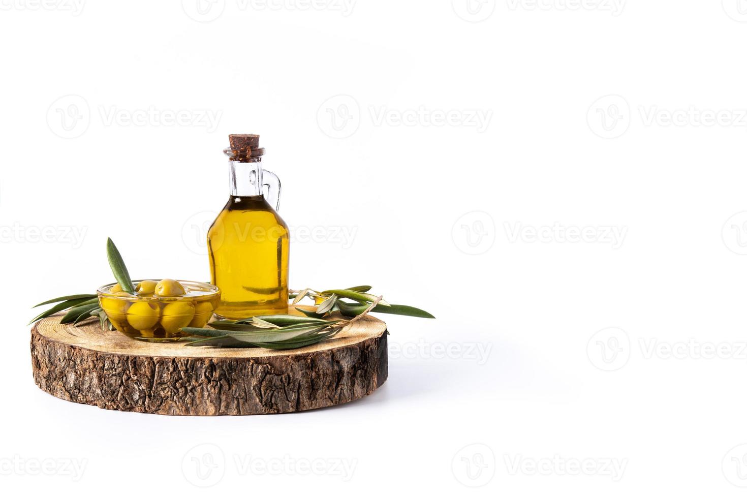 natives Olivenöl mit grünen Oliven in Kristallschale isoliert auf weißem Hintergrund foto
