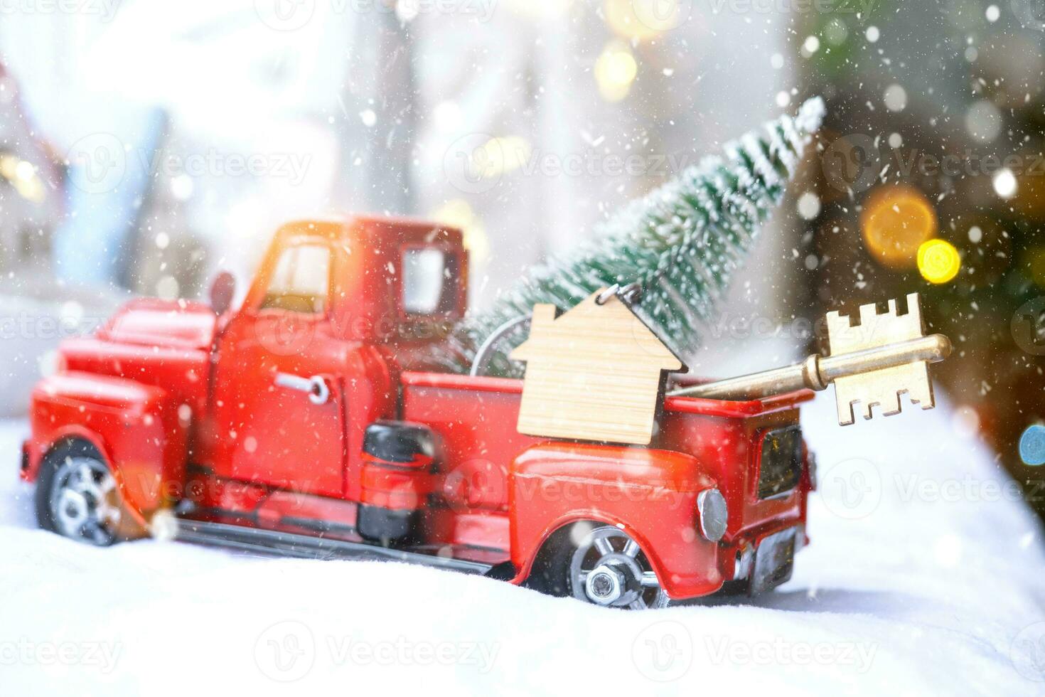 Rotes Retro-Auto mit einem Weihnachtsbaum schmückt mit dem Hausschlüssel im Pickup-Truck zu Weihnachten. Hauskauf, Umzug, Hypothek, Darlehen, Immobilien, Feststimmung, Neujahr foto