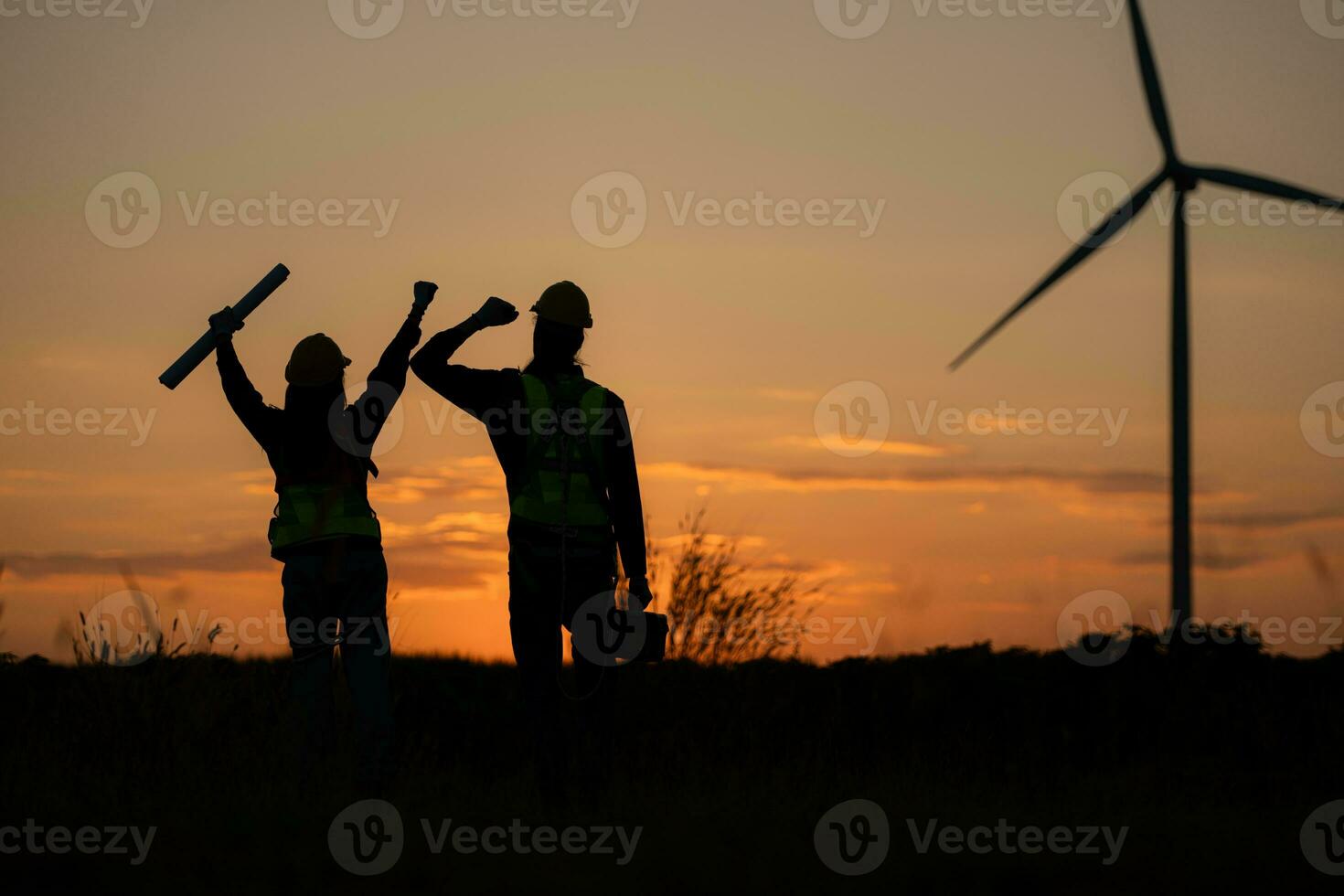 Silhouette von Ingenieur im aufladen von Wind Energie gegen ein Hintergrund von Wind Turbinen. foto