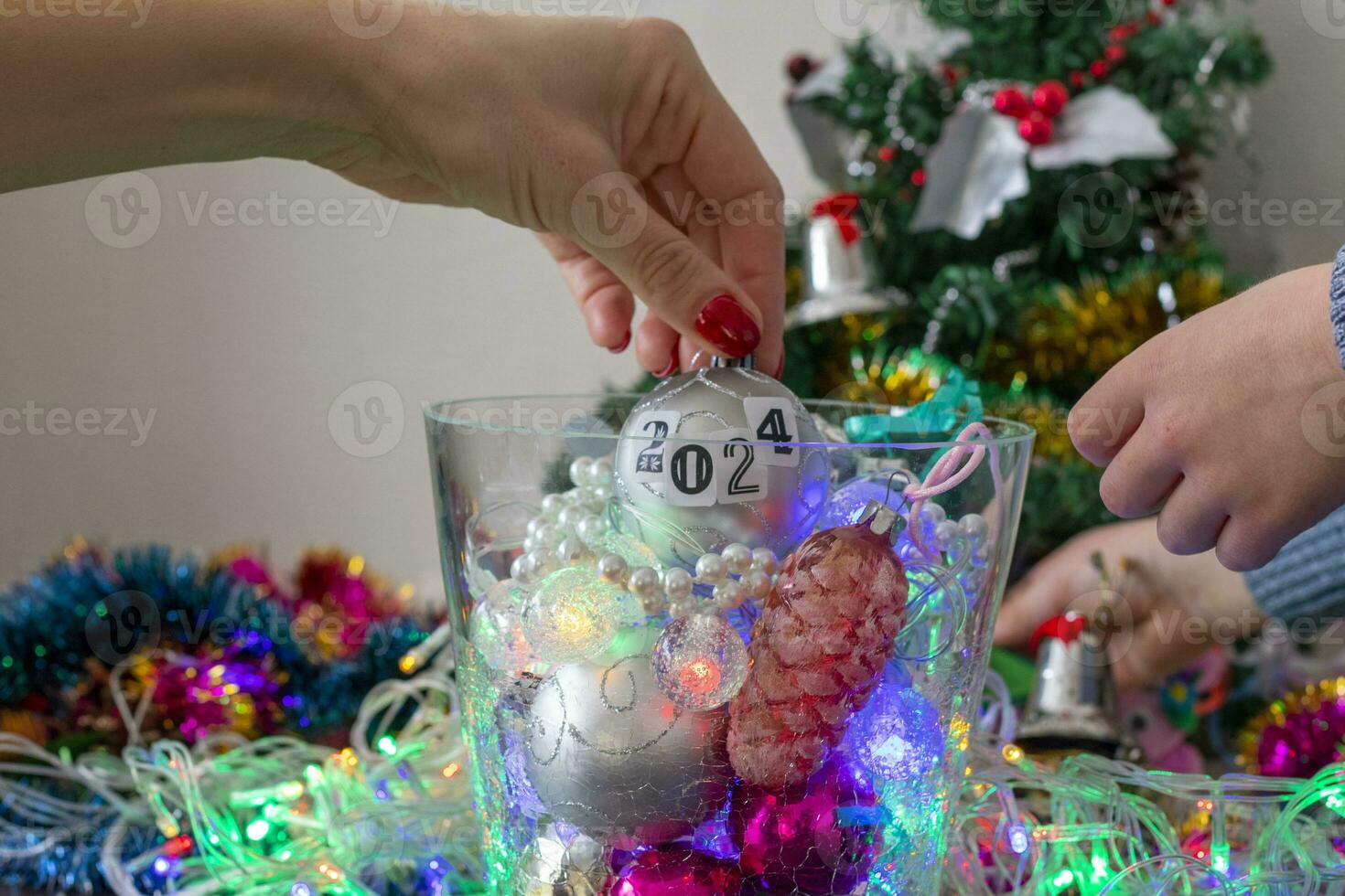 schließen oben Schuss von Frau und wenig Junge dekorieren Weihnachten Baum. Neu Jahr Ändern Zahlen. Urlaub foto