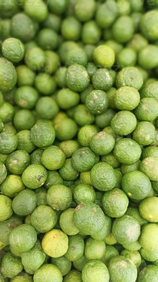 Limette Obst Hintergrund , Stapel von Grün Limette Früchte foto