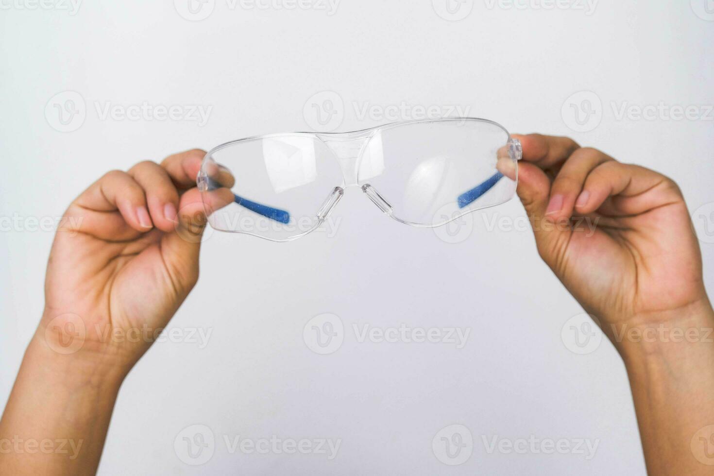 Hand halten Sicherheit Gläser, persönlich schützend Ausrüstung. schützend Brille im Hand isoliert auf Weiß Hintergrund. foto