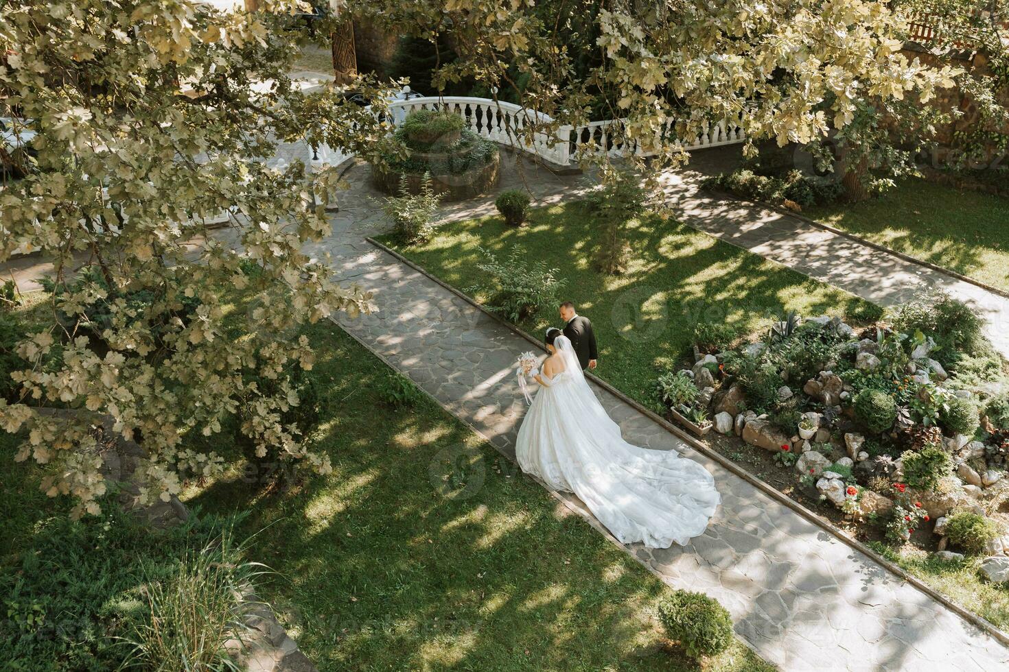 jung schön Hochzeit Paar halten Hände Gehen im das Garten, Foto von über