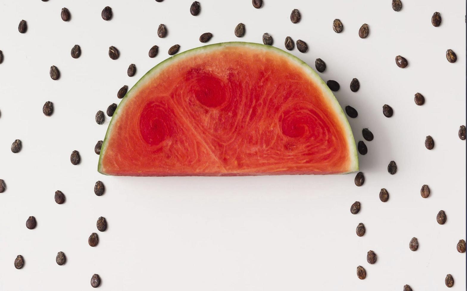 Illustration einer bunten Wassermelone mit ihren schwarzen Samen, die an einem Sommertag genossen werden kann foto