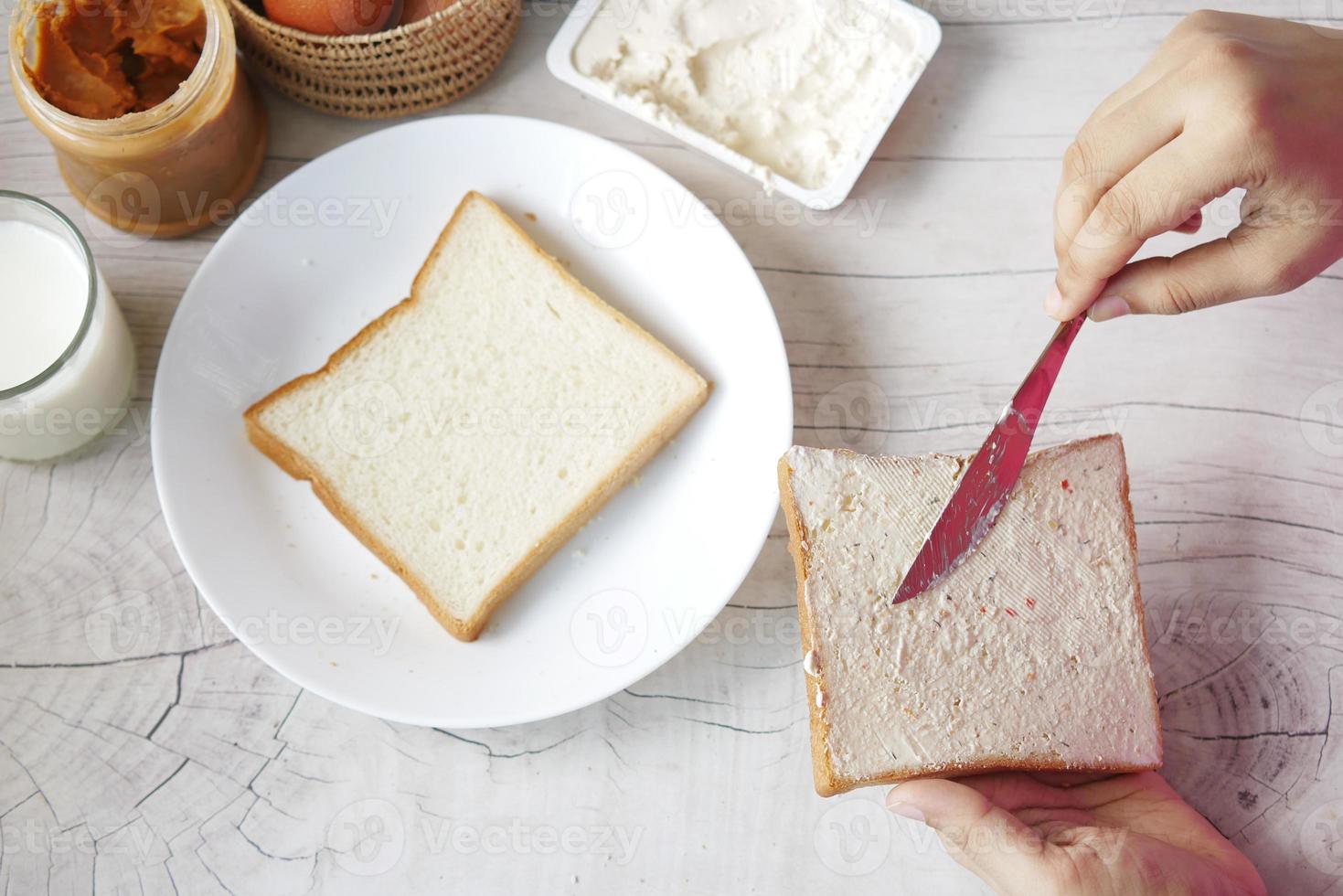 Low-Fact-Käsecreme auf einem Brot auf dem Tisch gestrichen foto