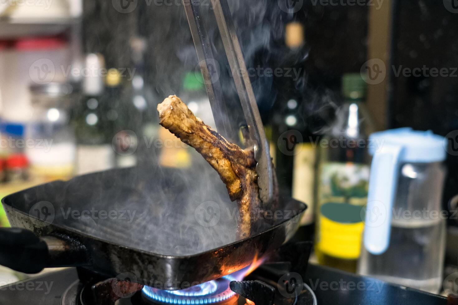 Zange Küche klemmen reif Rindfleisch Steak auf schwenken foto