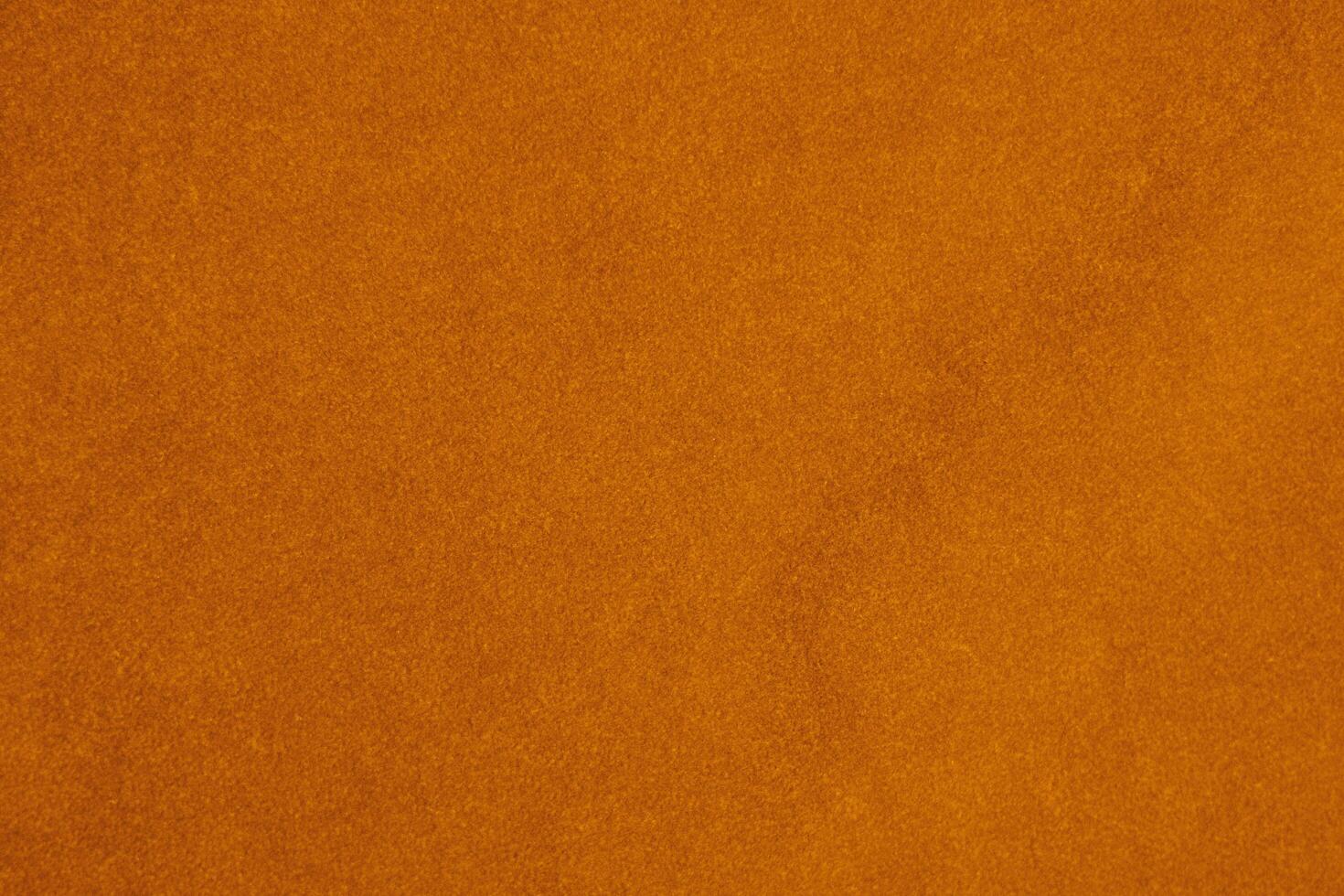 Licht Orange Samt Stoff Textur benutzt wie Hintergrund. Seide Farbe Safran Stoff Hintergrund von Sanft und glatt Textil- Material. zerquetscht Samt .Luxus Sonne Licht Ton zum Seide. foto