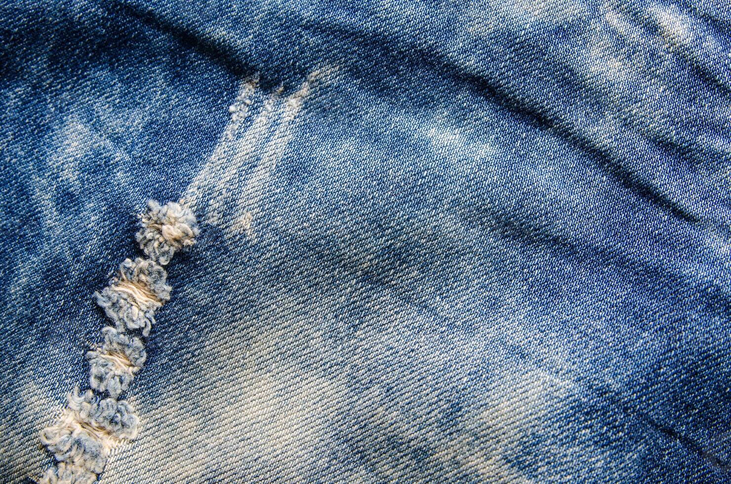 Falten Blau Jeans Textur. Jeans Hintergrund. foto