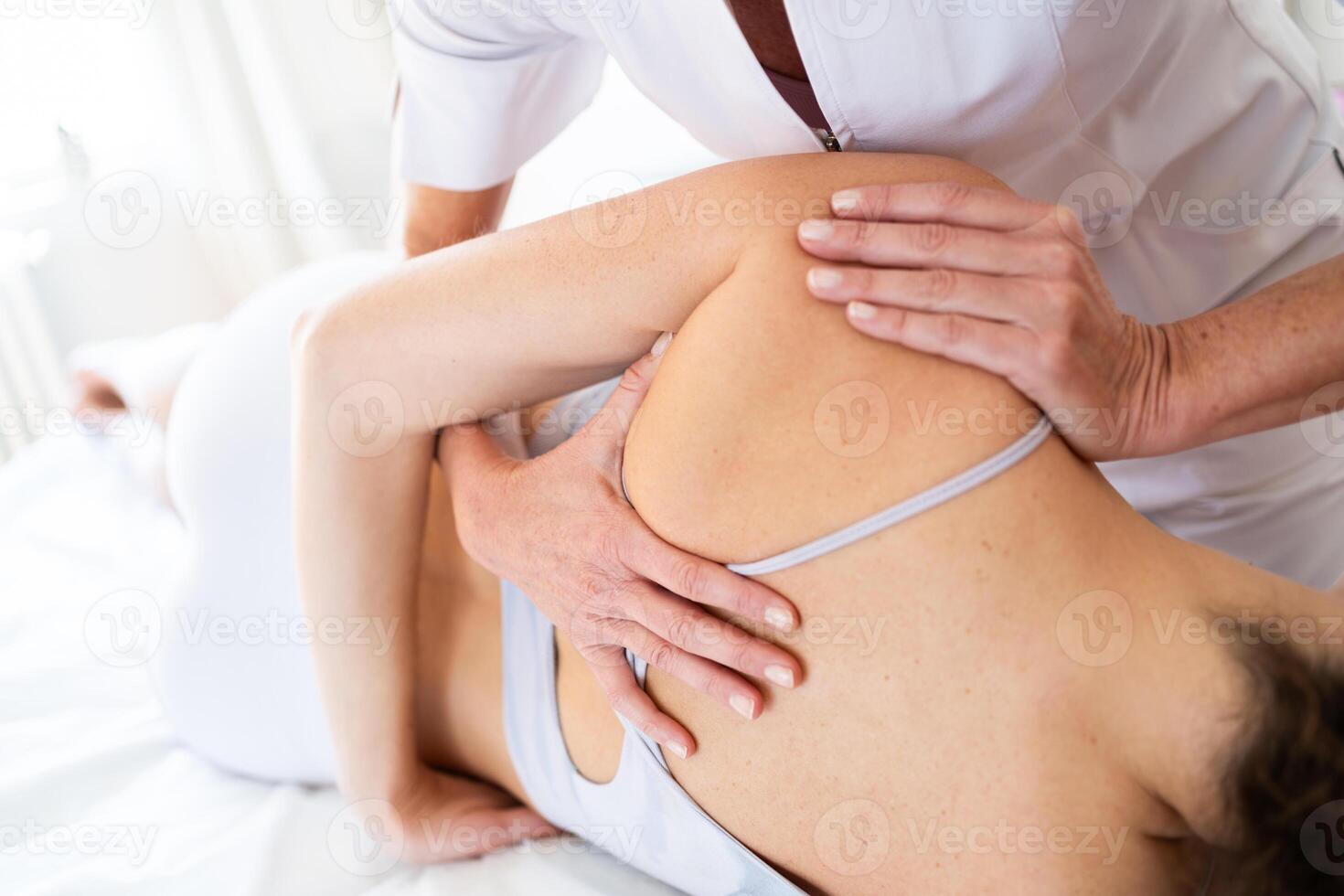 weiblich Osteopath tun Schulter Klinge Therapie auf geduldig foto