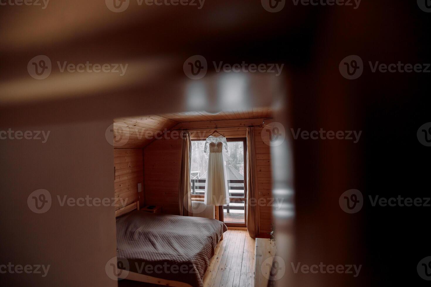 ein perfekt Hochzeit Kleid mit Spitze Ärmel auf ein Aufhänger im das Braut Zimmer. Vorbereitung von das Braut zum das Hochzeit foto