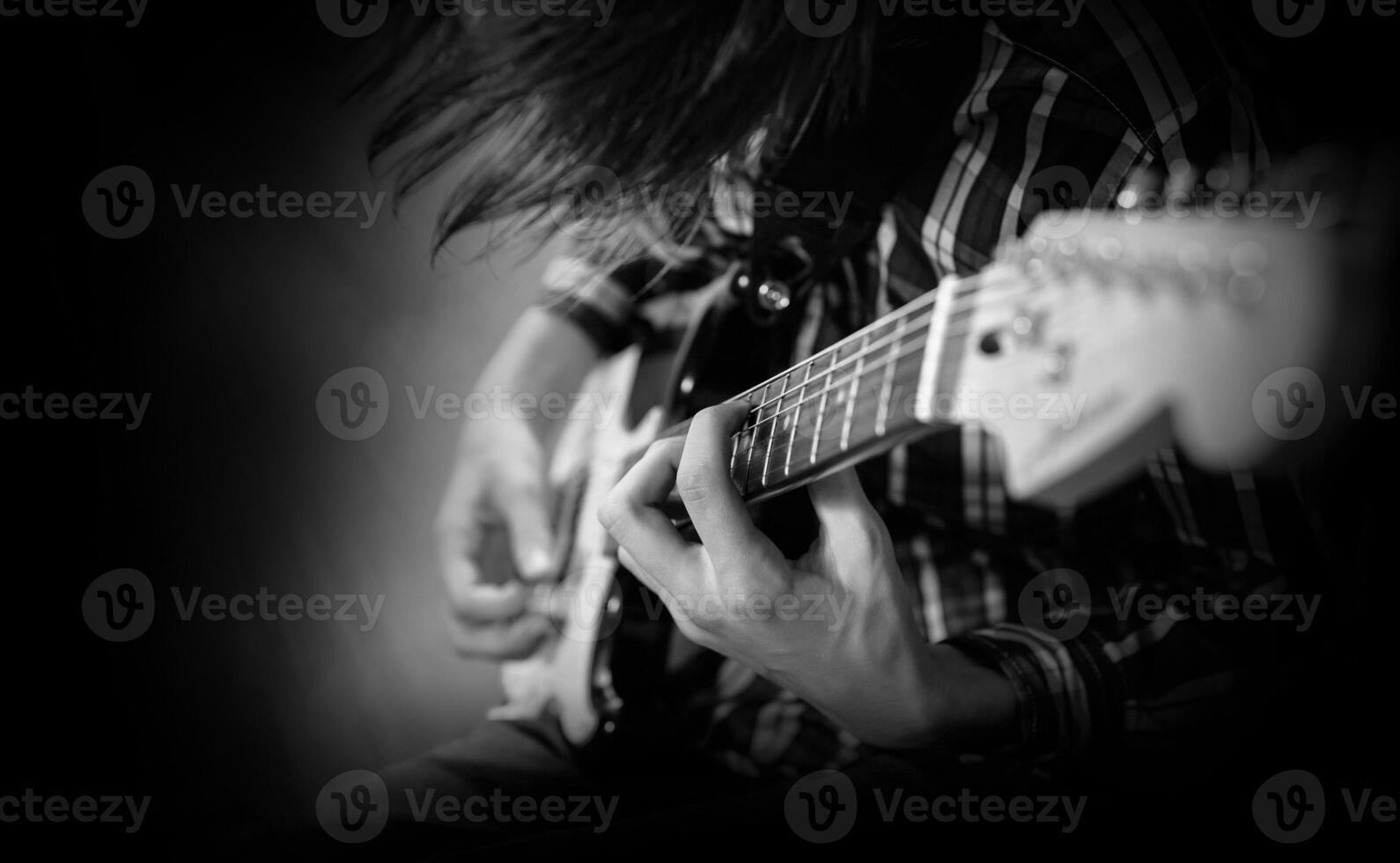 ein jung Mann Theaterstücke das elektrisch Gitarre foto