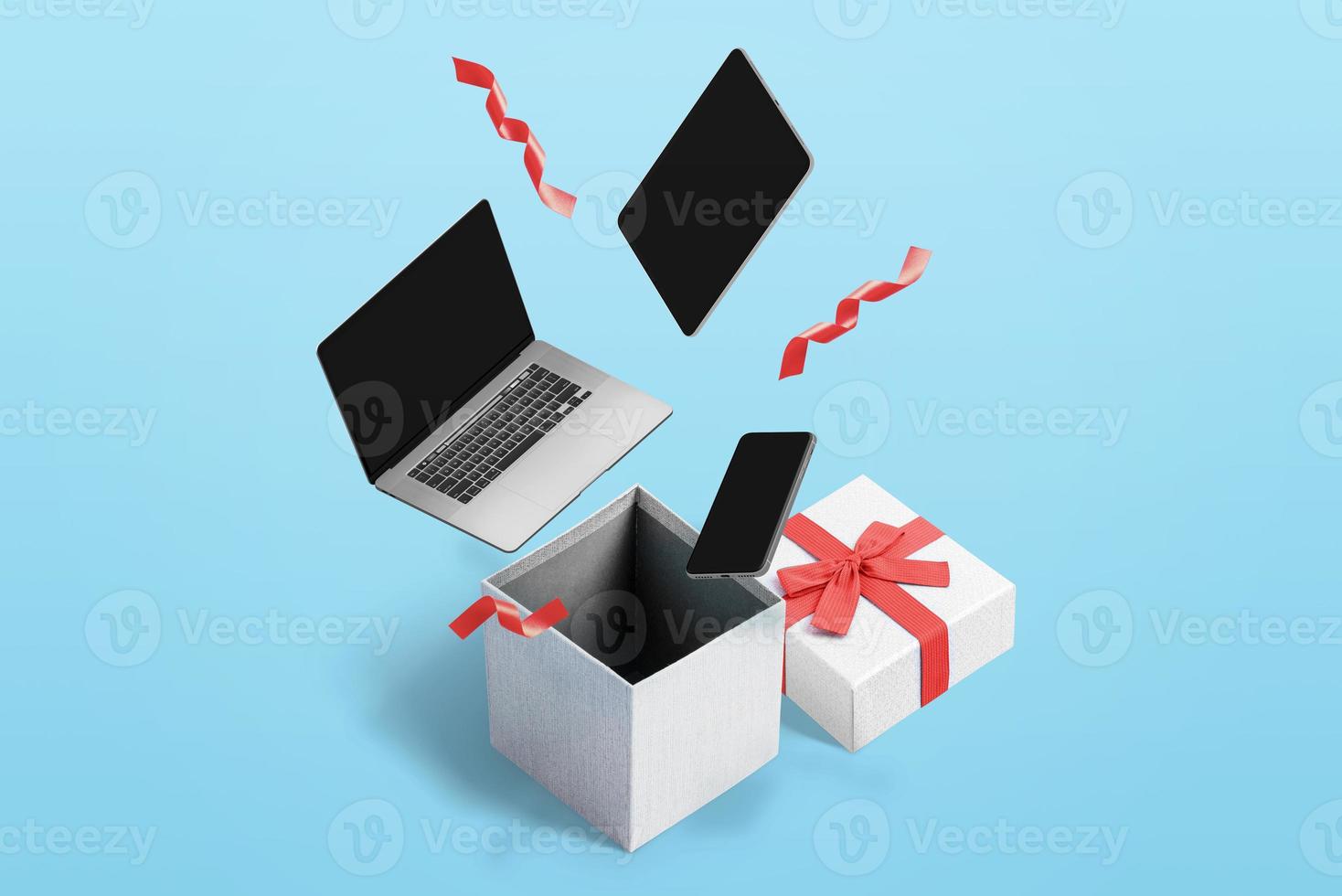 Konzept, Tech-Produkte zu kaufen und Geschenke für Weihnachten und Neujahr zu machen. Laptop, Tablet und Telefon in Geschenkbox foto