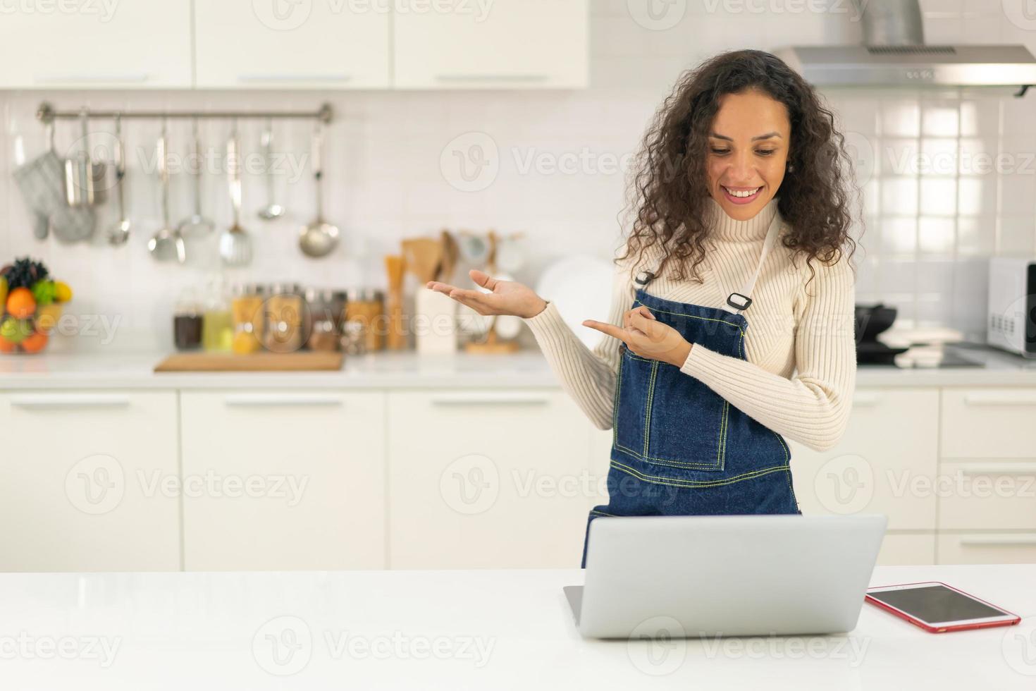 Latina dreht Video und kocht in der Küche foto