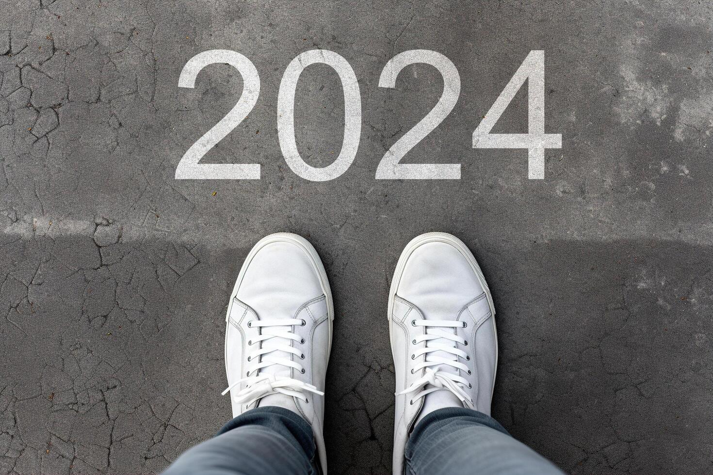 ai generiert Nummer 2024 gezeichnet auf geknackt Asphalt, Füße im Schuhe Stehen auf Boden. Konzept von das Kommen Neu Jahr 2024. oben Sicht, POV, Nahansicht foto