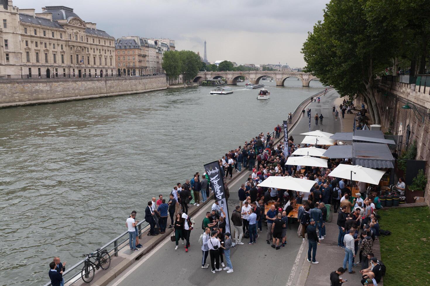 Paris, Frankreich 01 Juni 2018 ein Begleiter von jung Menschen Getränke und isst auf das Banken von das Fluss Seine im das Center von Paris. Konzept Picknick im das Stadt. Bier Unterhaltung Party foto