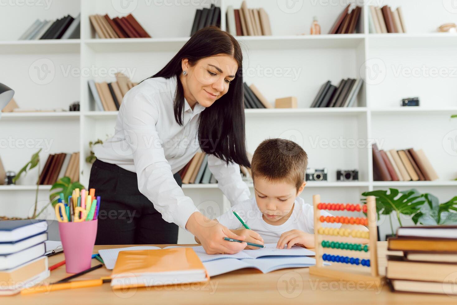 Tutor Angebote mit das Vorschulkind mit ein Laptop, ein echt Zuhause Innere, das Konzept von Kindheit und Lernen foto