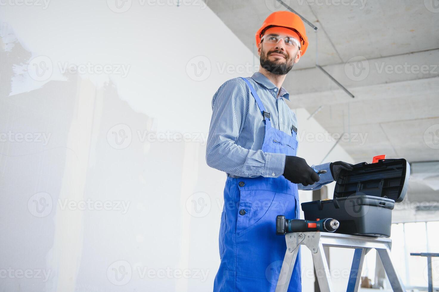 Baumeister auf Konstruktion Seite? ˅ mit Werkzeug Box foto