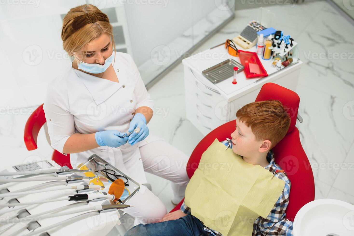 weiblich Zahnarzt und Kind im ein Zahnarzt Büro foto