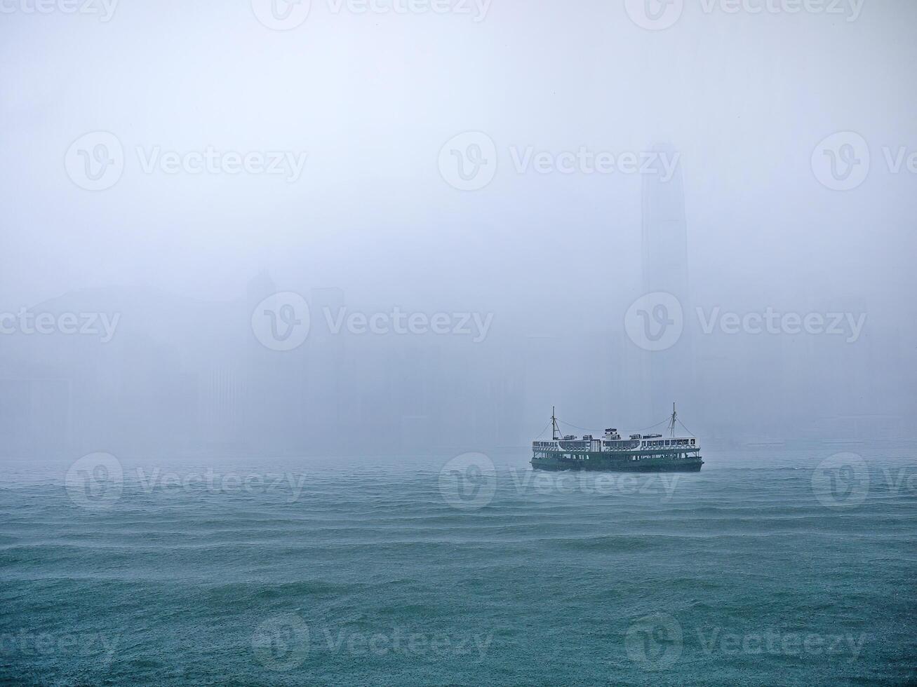 ein Fähre Transport im schwer Regen beim Victoria Hafen, Hong Kong, bunt Wasser Boot Taxi, Schiff, berühmt Fähre zum Täglich Leben und Tourismus, grau Regen Nebel im das Hintergrund foto